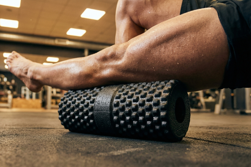 Foam rolling legs for muscle recovery and soreness relief